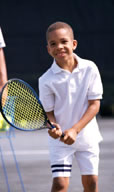 Boy learning tennis